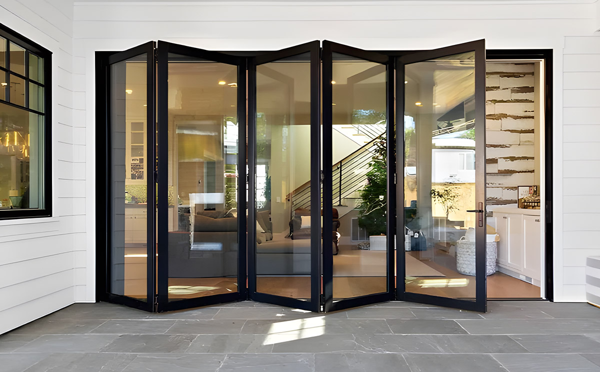 Black Frame Multi-panel Folding Glass Door Transitioning Interior Living Area to Deck