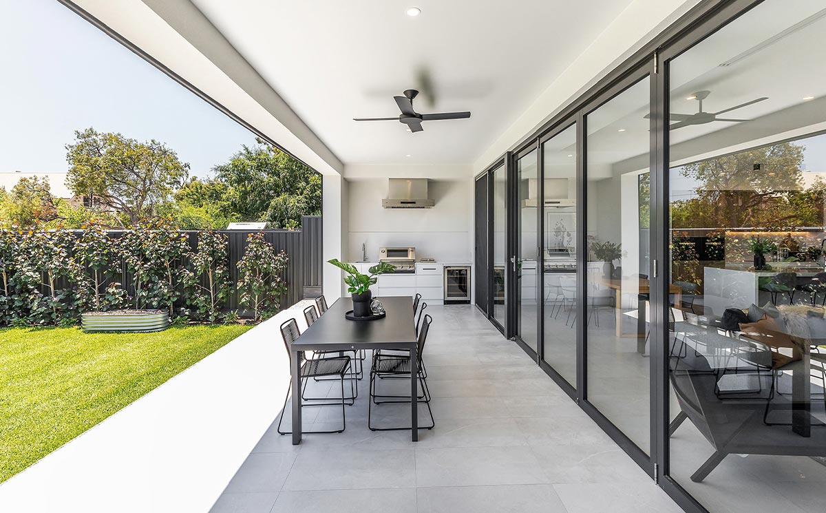 Modern Villa Covered Patio with Large Glass Wall and Outdoor Dining Space