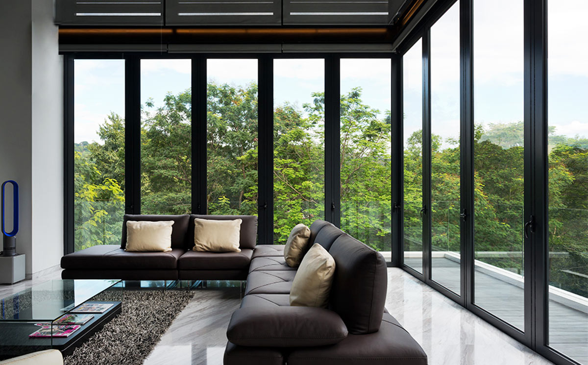 Luxury Villa Living Room with Panoramic Corner Folding Glass Doors Looking at Greenery
