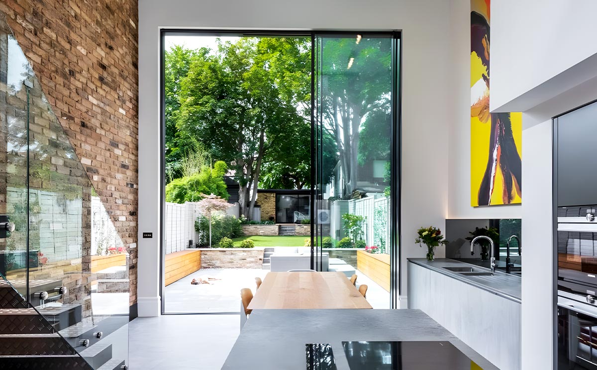 Open Concept Floor-to-Ceiling Slim Frame Sliding Door Transitioning to Outdoor Terrace
