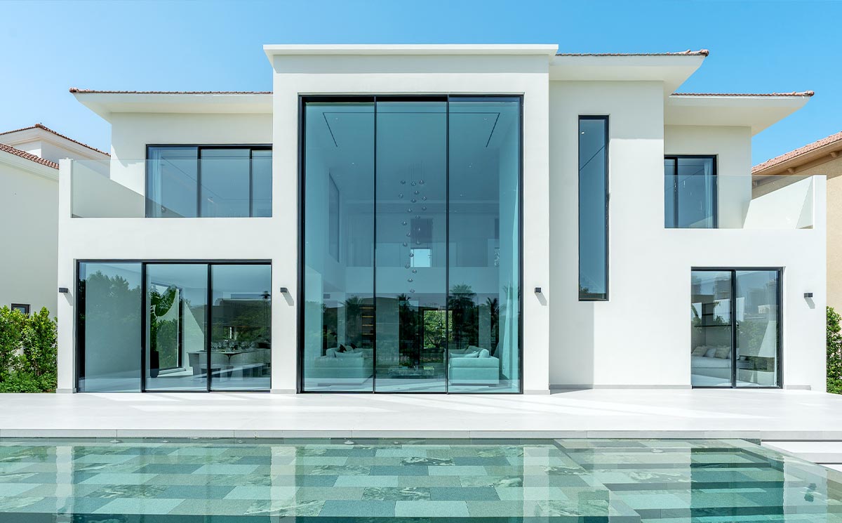 Luxury Villa Interior Facing Exterior Landscape Through Slim Frame Patio Door