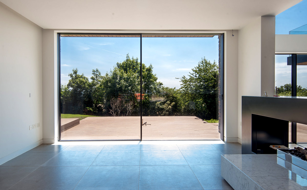 Black Frame Outdoor Patio Sliding Door Connecting Living Space to Deck