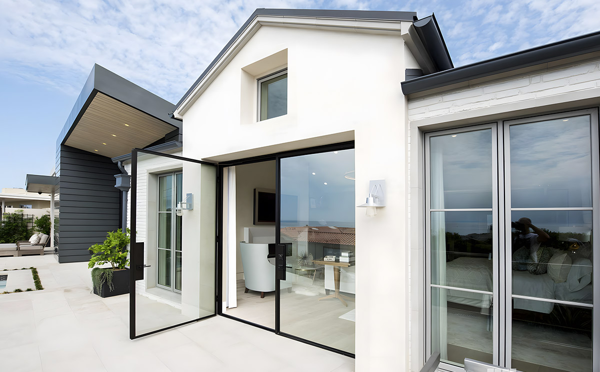Exterior slim aluminium French patio doors with large clear glass panel opening onto a modern outdoor pool terrace