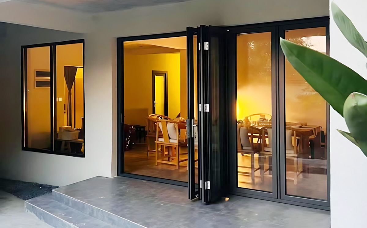 Aluminum glass folding doors open view connecting modern villa interior dining space to outdoor terrace