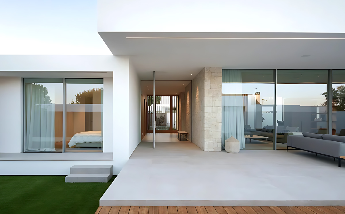 Luxury villa exterior facade featuring slim frame sliding doors and open patio terrace